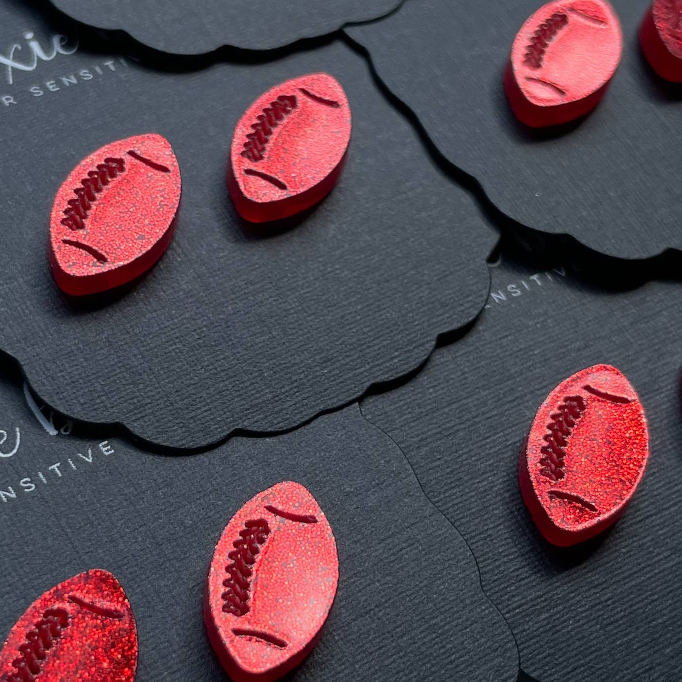 Red football stud earrings – game day accessory for women